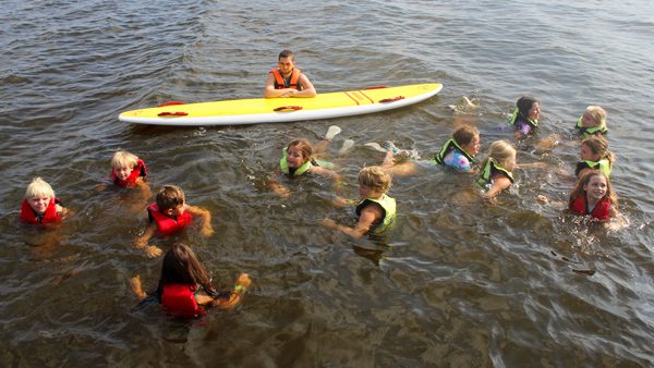 group in lake swimming