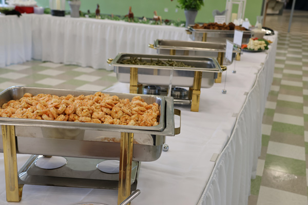 dinner buffet with shrimp, fried chicken, potatoes, roast beef, and green beans