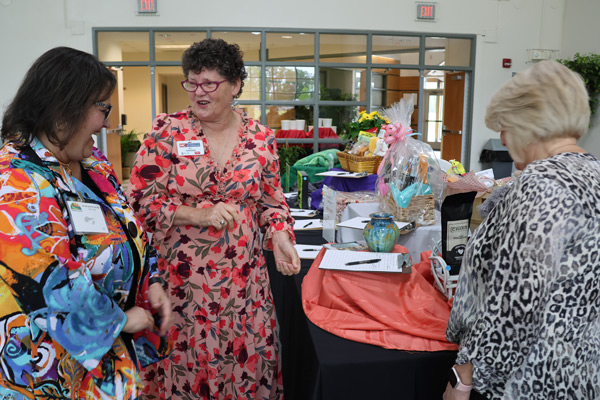 ladies talking around the silent auction table